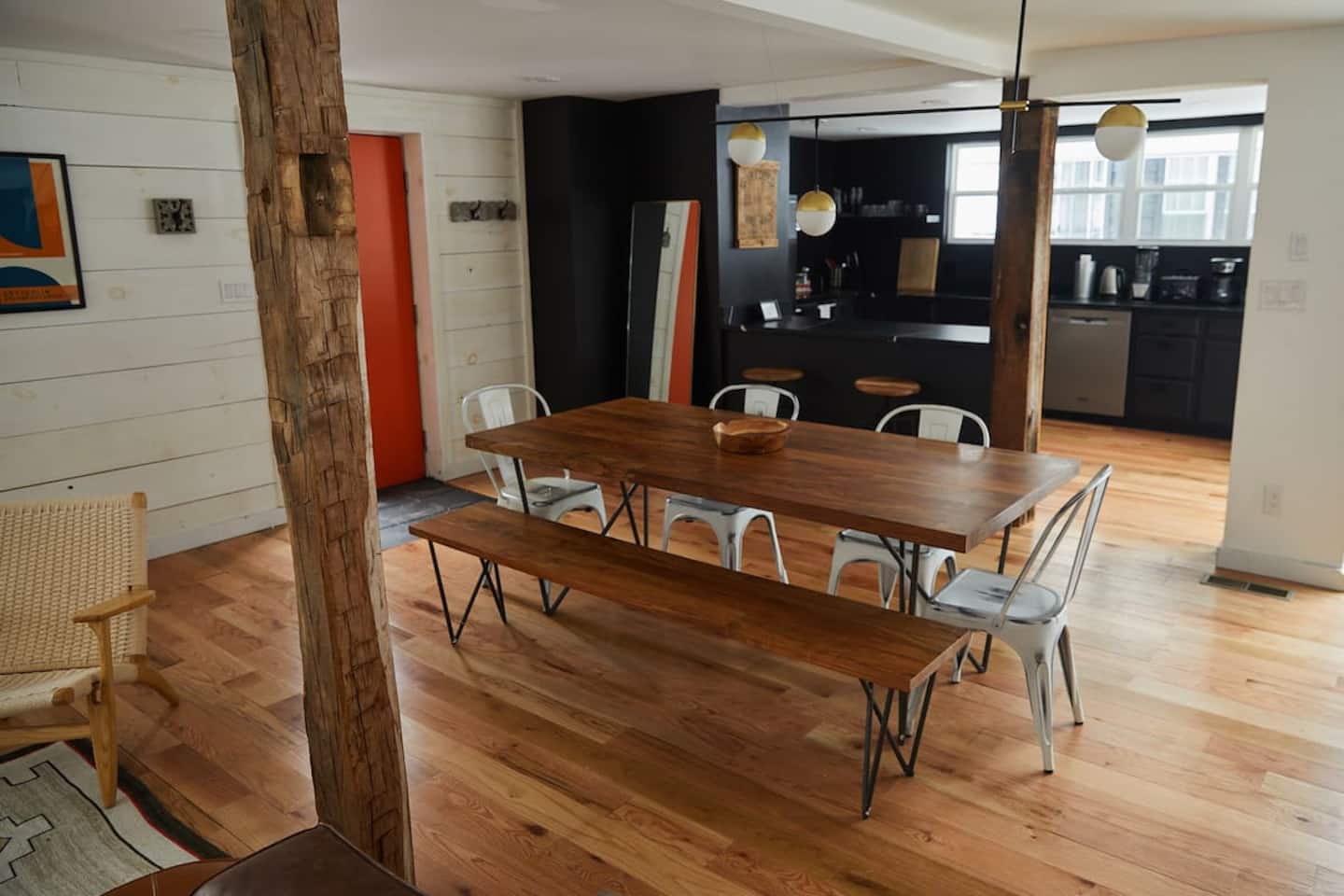 The oversized dining table by the signature orange door