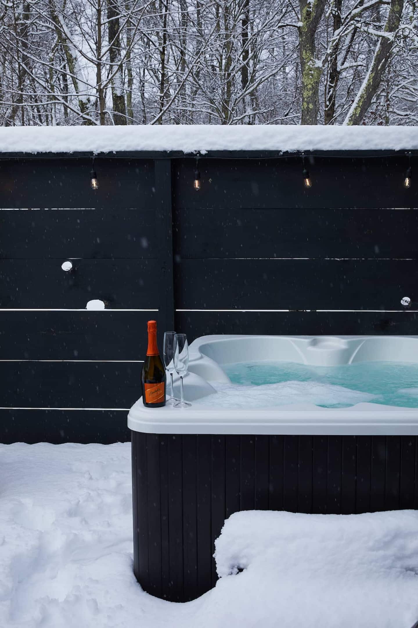 The hot tub on a snowy night, wine at the ready