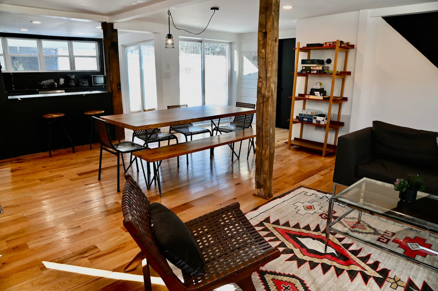 Open-plan dining and living space with exposed beams